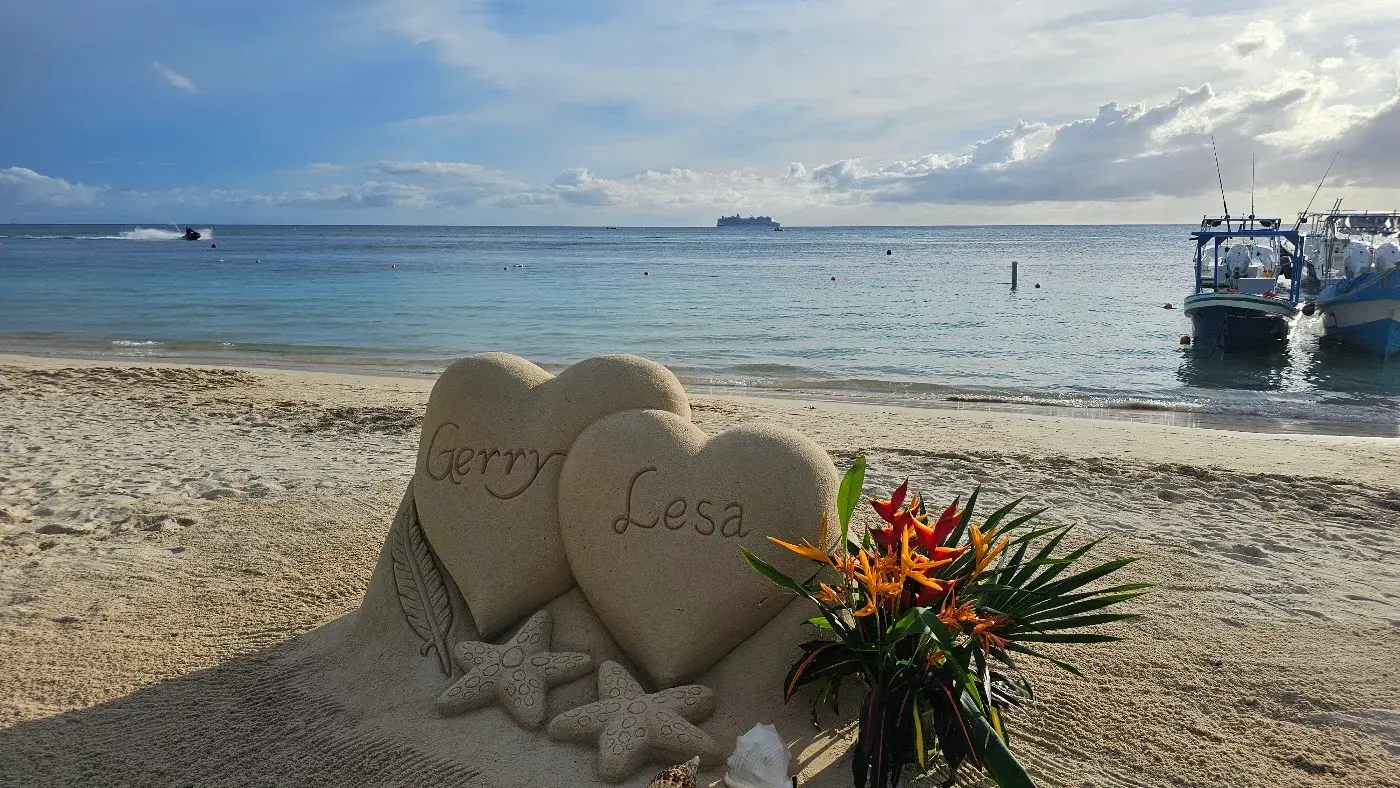 Roatan Fire Tours 28 Two hearts with names and tropical flowers, sand sculpture on a Roatan beach